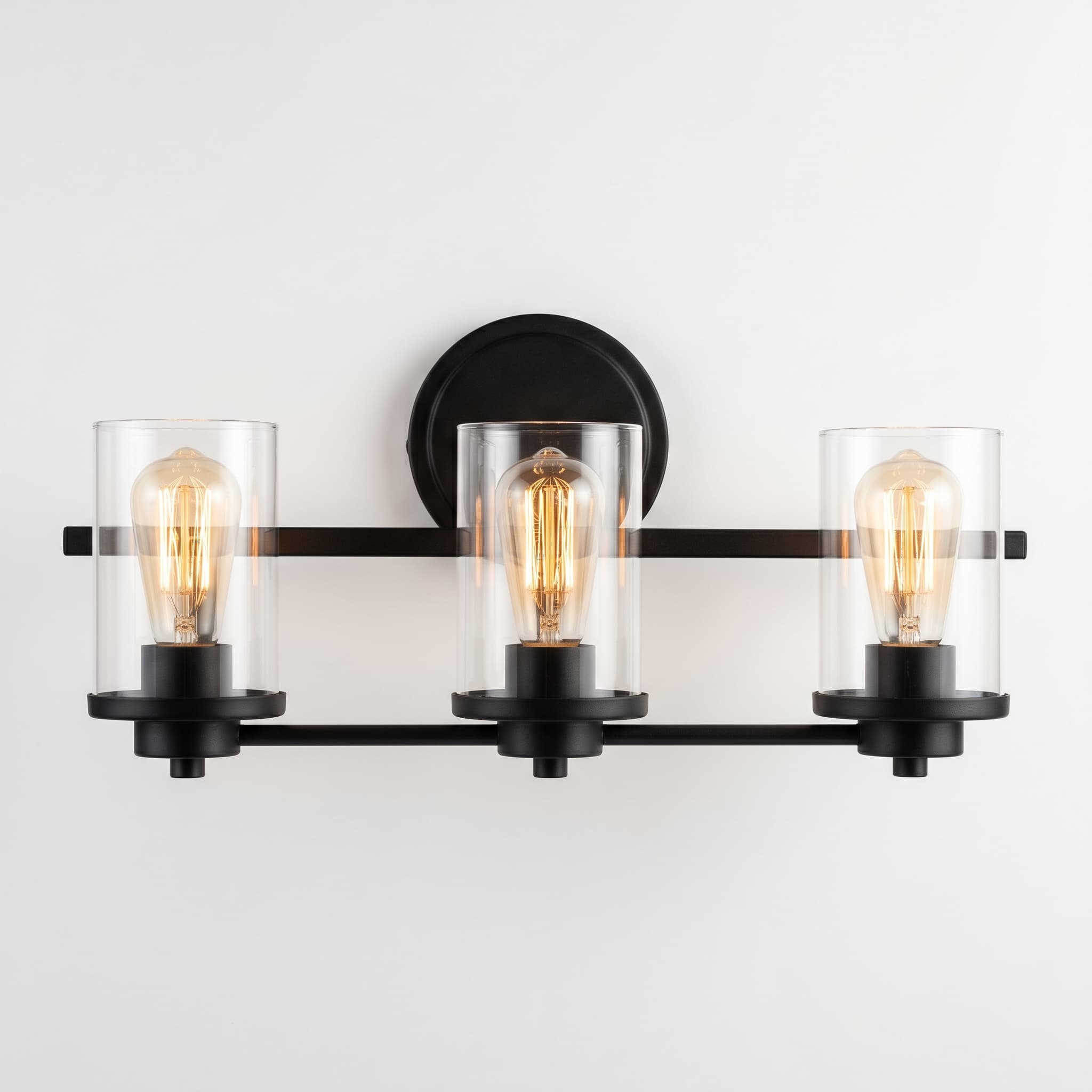Three-light bath vanity bar with matte black frame and clear cylindrical glass shades