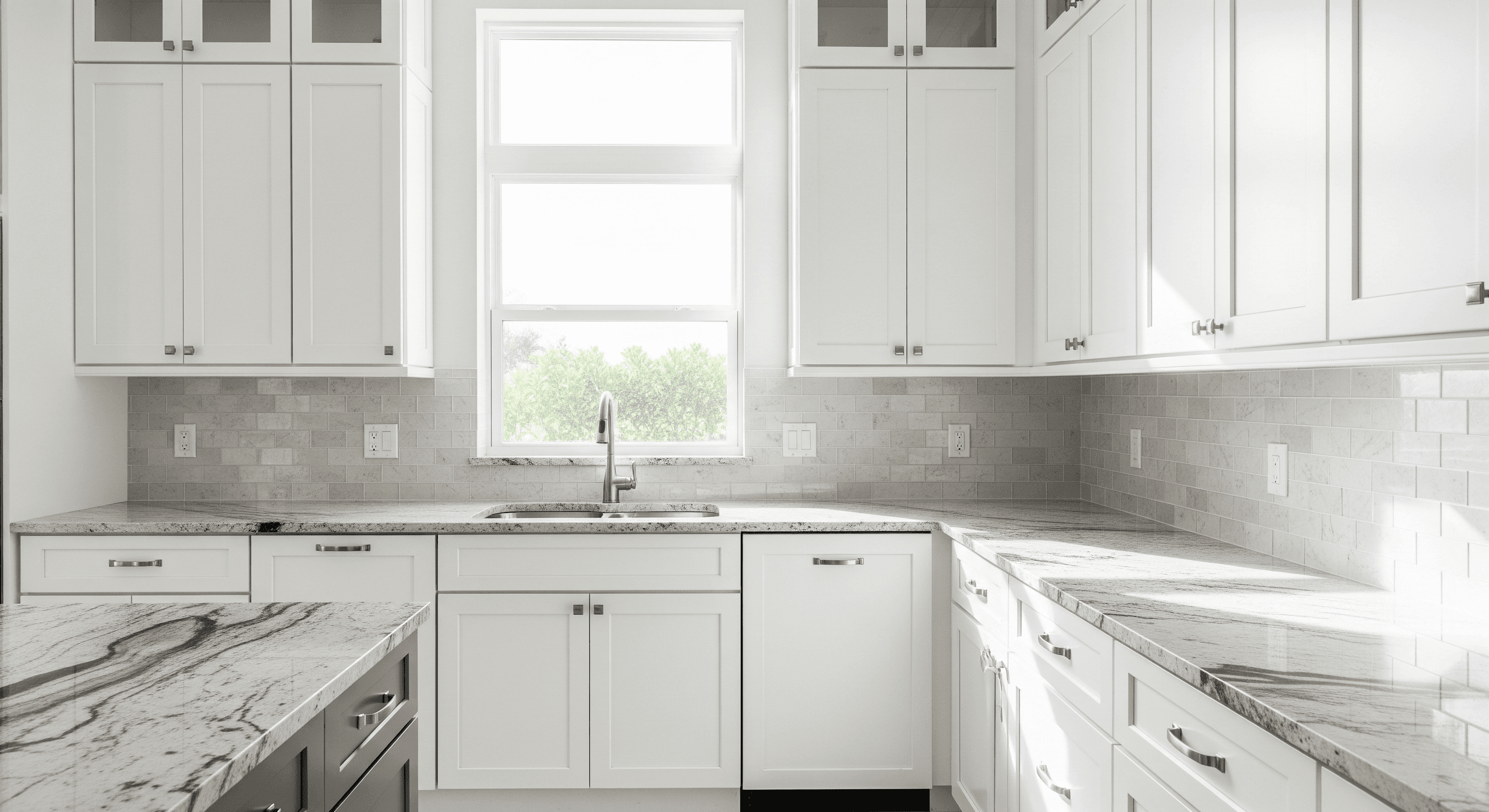 Florida kitchen interior with white shaker cabinetry, polished granite countertops, and brushed nickel hardware