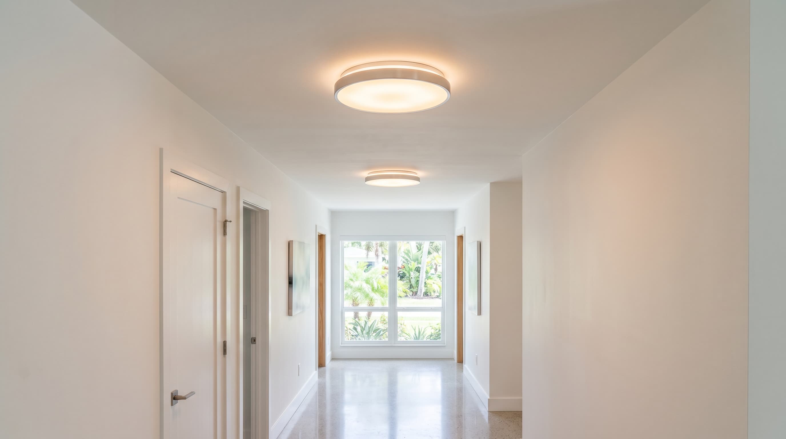 Florida hallway ceiling with flush-mount LED disc ceiling lamps glowing softly