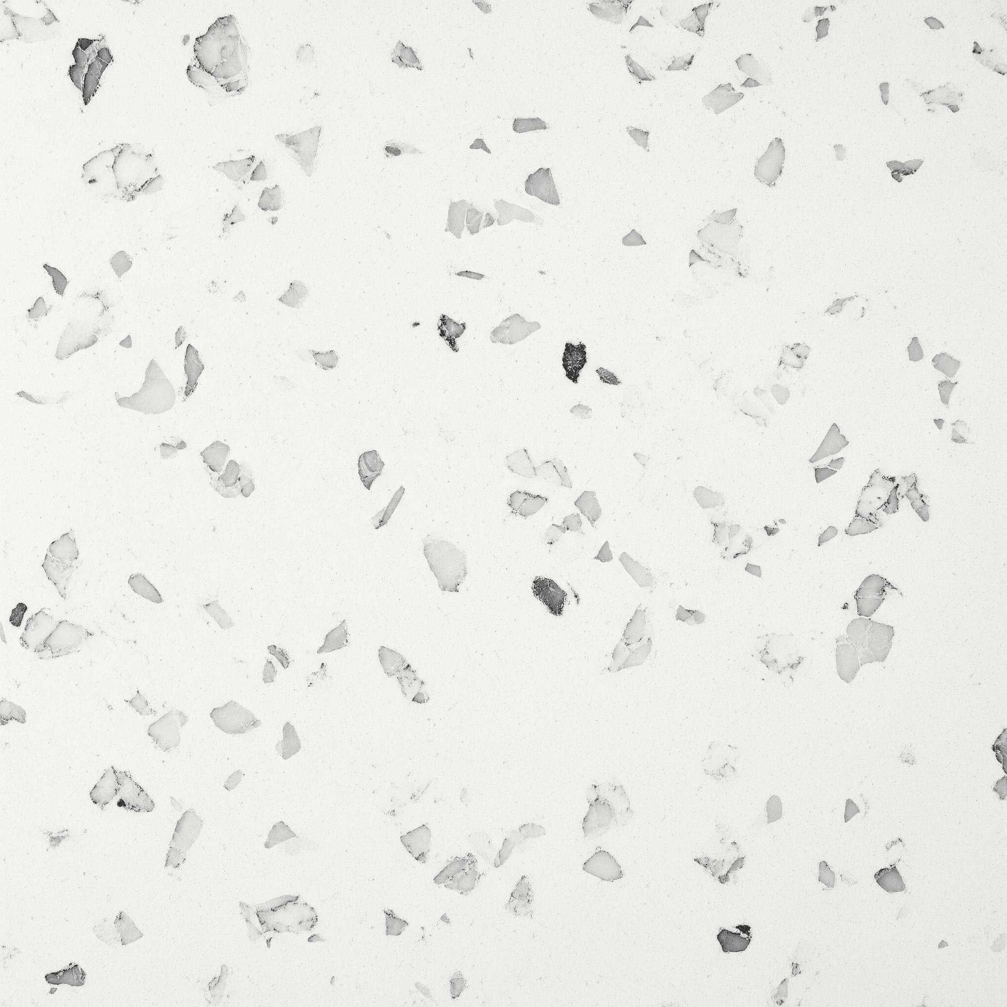 Ice White quartz — clean cool white surface with small charcoal-gray and pale terrazzo flecks
