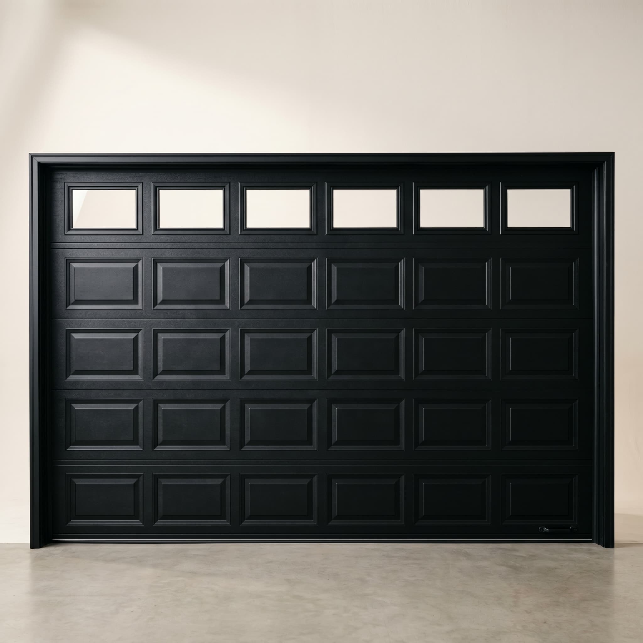 Matte black raised-panel garage door with horizontal window row