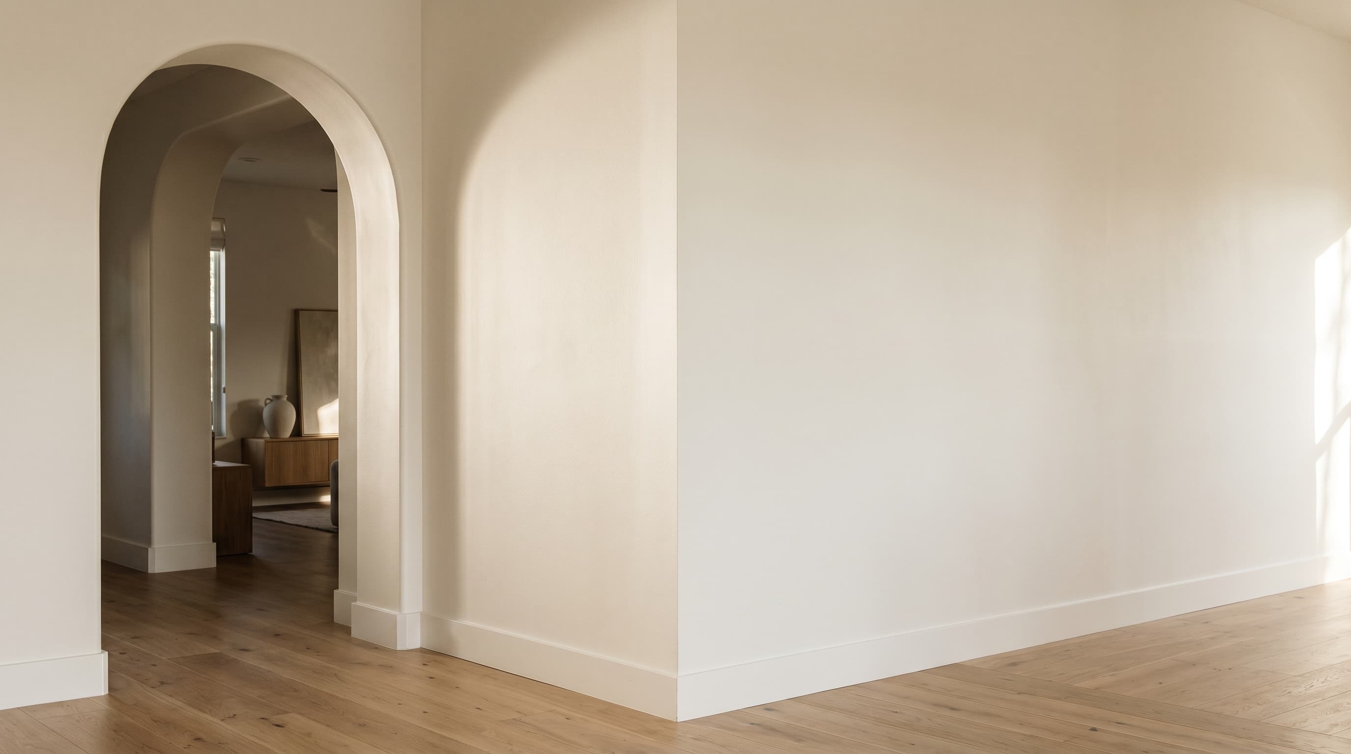 Florida home interior wall corner painted in soft warm white with raking afternoon daylight