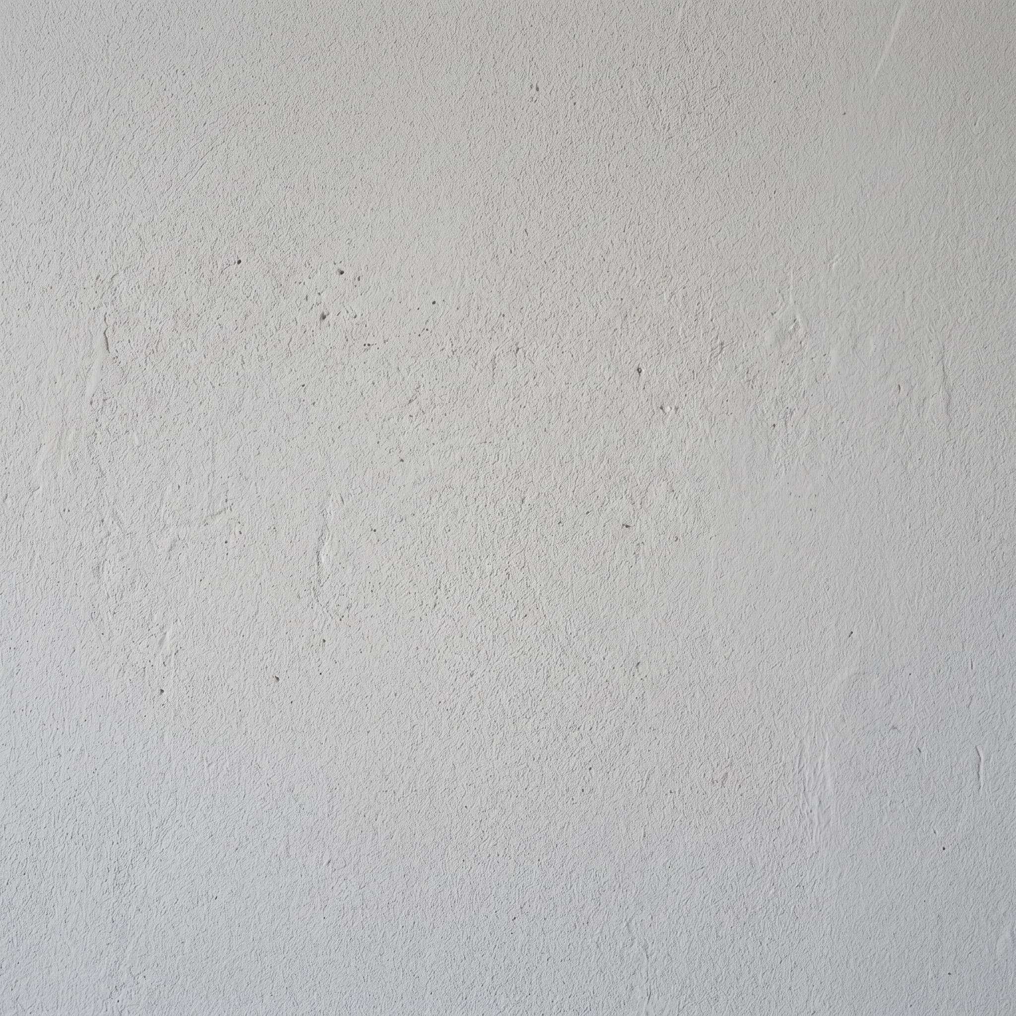 Sherwin-Williams flat light gray interior paint swatch on plaster wall