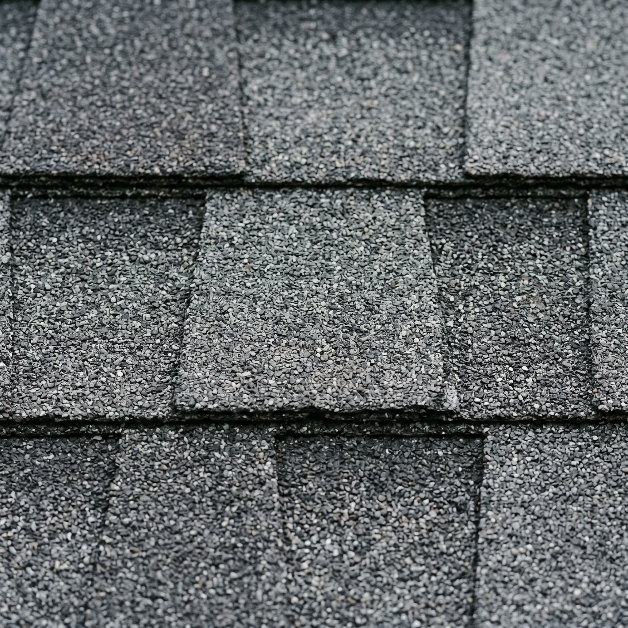 Charcoal-gray architectural asphalt shingles with silver-gray granule variation