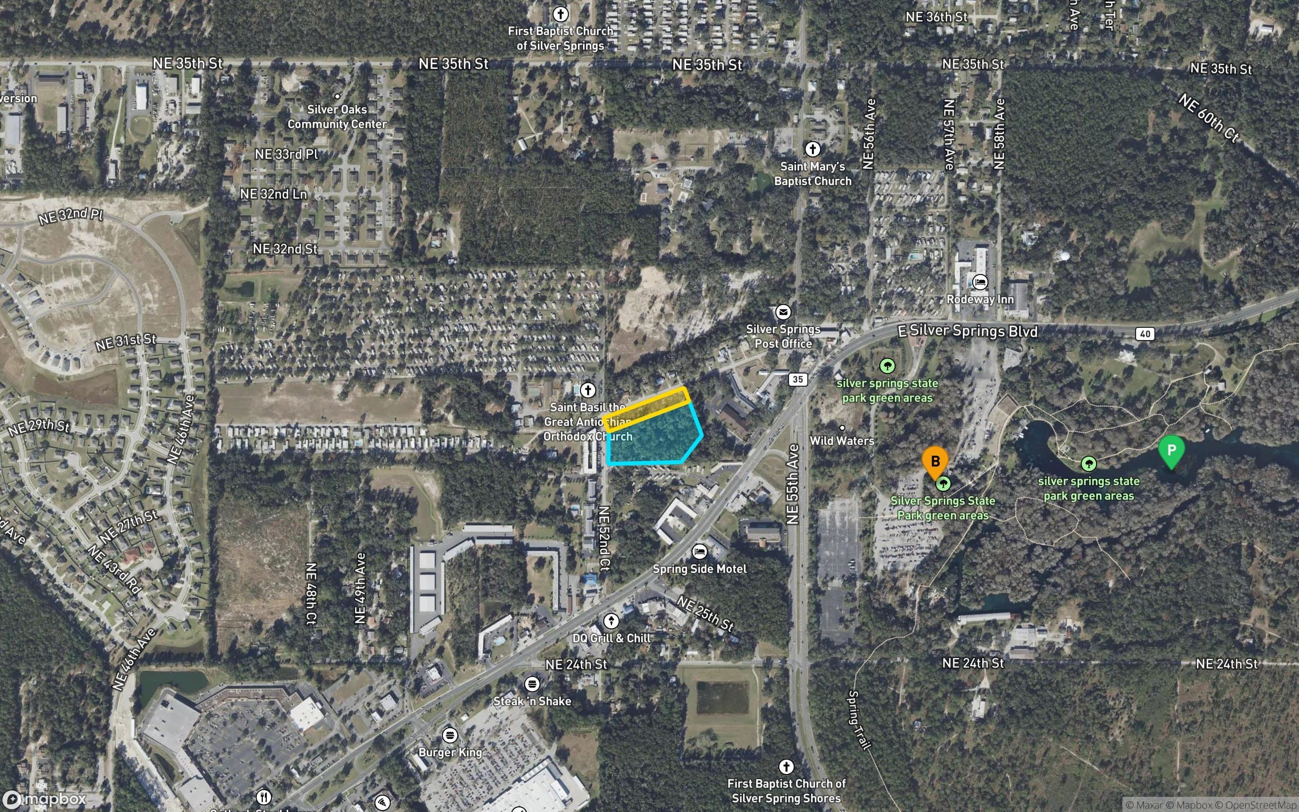 Mapbox satellite neighborhood view with the two Pointe at Silver Springs parcels outlined in gold and aqua, plus an amber B pin marking East Silver Springs Blvd and a green P pin marking the Silver Springs State Park headsprings to the east