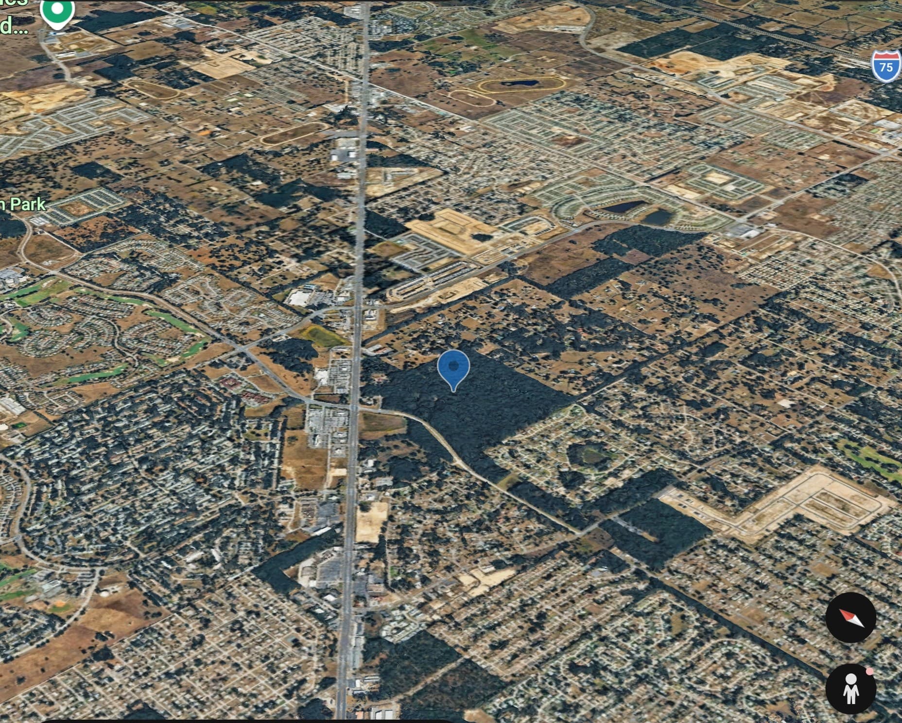 Tilted Google Earth aerial of the SW Hwy 200 parcel pinned in context — Highway 200 corridor running through the frame with surrounding residential subdivisions and commercial development on either side, Marion Park to the west and I-75 visible to the north-east