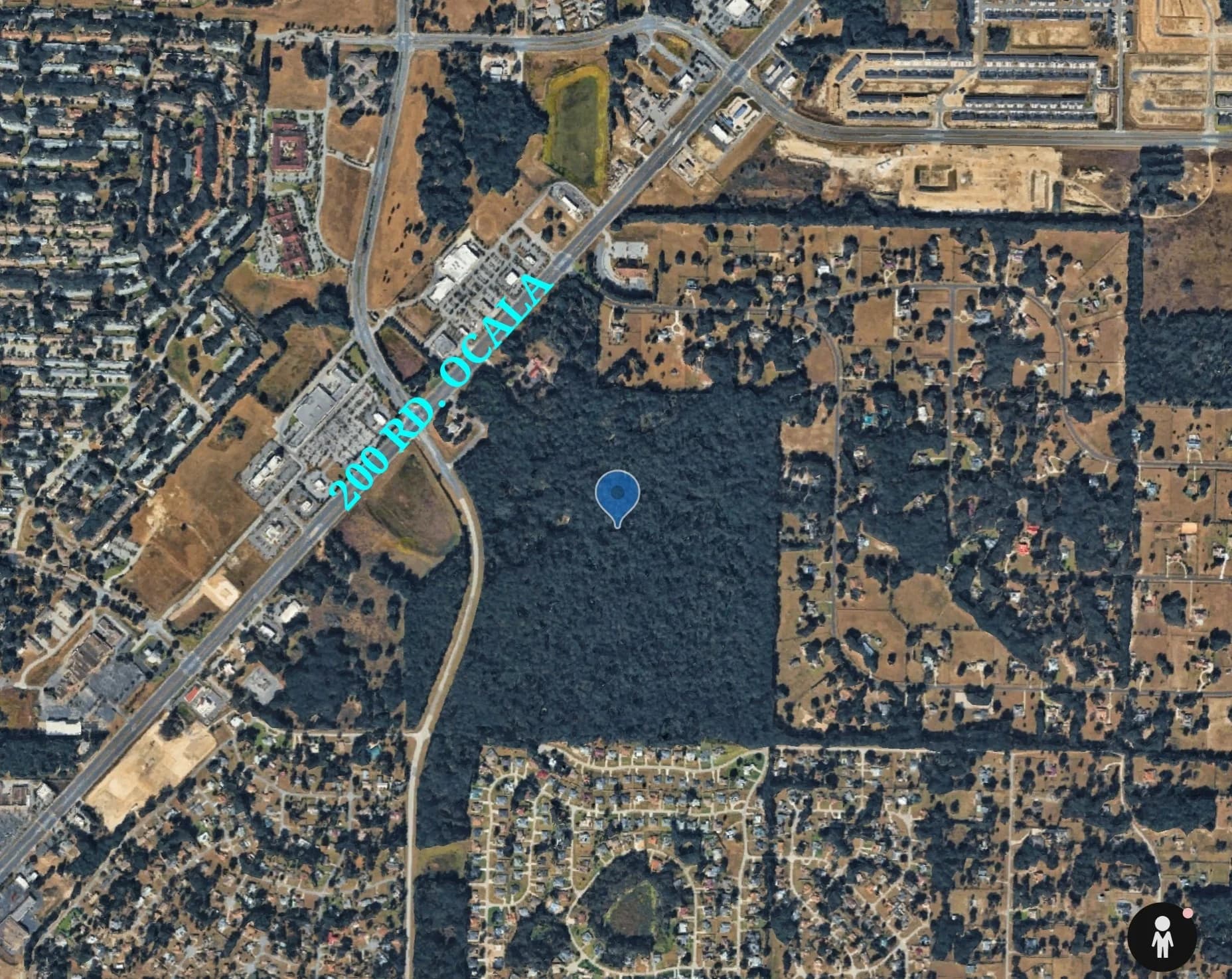 Satellite view of the 111-acre SW Hwy 200 parcel marked in context — Walmart commercial corridor to the north-east, residential neighborhoods on the south and west, Highway 200 running diagonally on the west edge